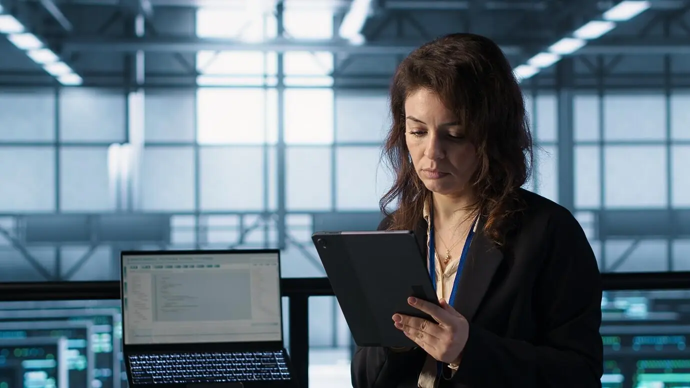 Admin im Rechenzentrum, der KI-Technologie auf einem Tablet verwendet.